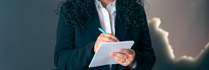 Business woman making entries in her notepad, stock photo