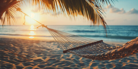 Hammock between palm trees on an idyllic tropical beach at golden sunset, beautiful ocean view. Exotic travel mood, summer vacation background concept. - obrazy, fototapety, plakaty