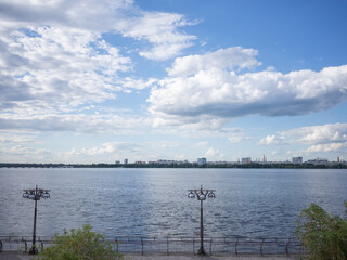 Fototapeta na wymiar scenery of dnipro river, cloudy sky, and cityscape over it
