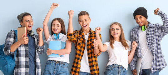 Portrait of happy young students on color background - 780136792
