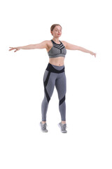 Sporty young woman balancing on white background