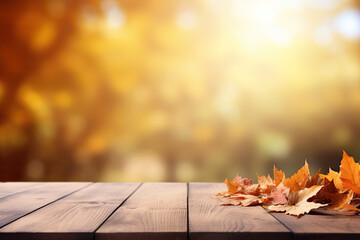 Naklejka na ściany i meble Golden Autumn Sunshine on a Wooden Table with Scattered Fall Leaves. copy space