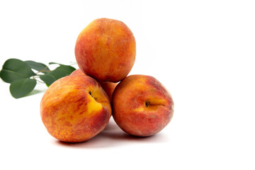 Three (3) fresh, ripe peaches isolated on white