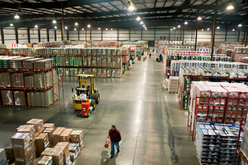 Efficient Distribution Hub: Forklifts and Workers Managing Industrial Warehouse Operations