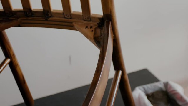 Restoration of a wooden chair. Covering with dark varnish. Close-up. Vintage things. High quality 4k footage