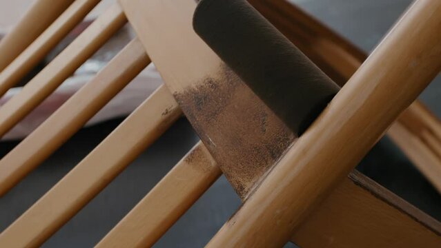 Restoration of a wooden chair. Covering with dark varnish. Close-up. Vintage things. High quality 4k footage