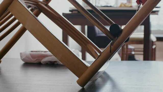 Restoration of a wooden chair. Covering with dark varnish. Close-up. Vintage things. High quality 4k footage