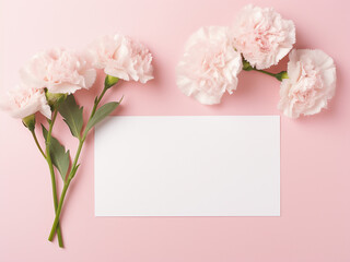 Pink and white carnations and blank card on pink