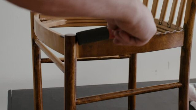 Restoration of a wooden chair. Covering with dark varnish. Close-up. Vintage things. High quality 4k footage