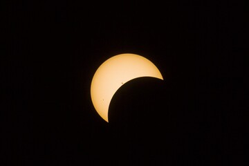 The image showcases a sun during the middle of an eclipse event. 
