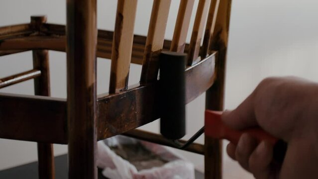Restoration of a wooden chair. Covering with dark varnish. Close-up. Vintage things. High quality 4k footage