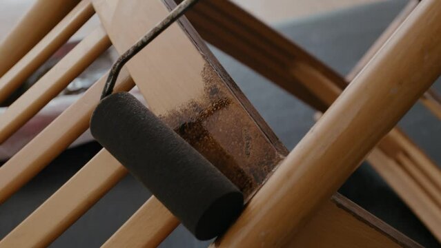 Restoration of a wooden chair. Covering with dark varnish. Close-up. Vintage things. High quality 4k footage