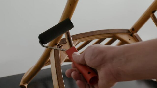 Restoration of a wooden chair. Covering with dark varnish. Close-up. Vintage things. High quality 4k footage