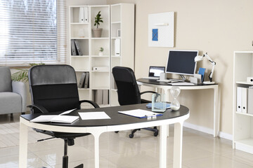 Modern workplace with notebooks and hourglass in office