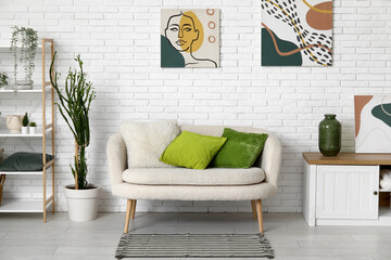 Stylish interior of living room with comfortable sofa and olive pillows - obrazy, fototapety, plakaty