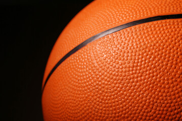 Ball for playing basketball game on black background, closeup