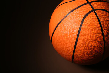 Ball for playing basketball game on dark background, closeup