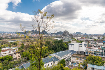 Summer landscape of Guilin town city with karst mountains in the background