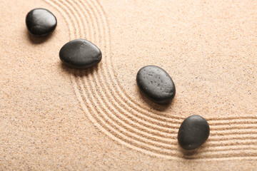 Stones on sand with lines