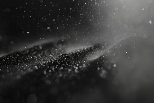 Abstract close-up of dust particles caught in sunlight, creating a mystical atmosphere in a monochrome setting.


