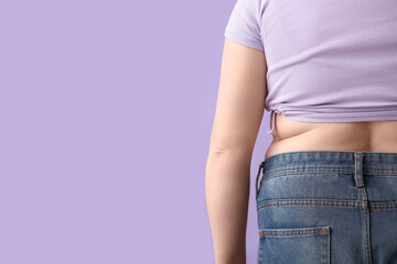 Overweight woman on lilac background, closeup. Diet concept