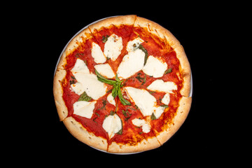 a classic Margherita ( or Margarita) pizza with fresh basil, slices of mozzarella cheese and tomato sauce isolated on black