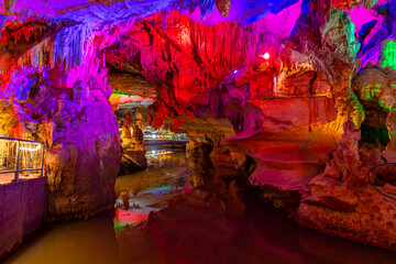 Stone stairs in Silver Cave, natural limestone cave with multicolored lighting