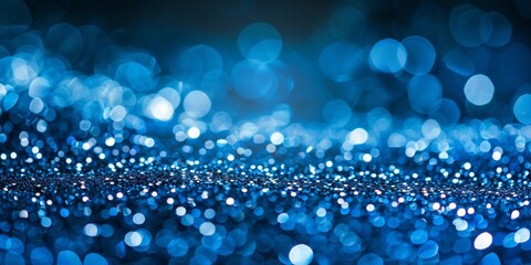 Glittering blue bokeh lights create a serene abstract background, perfect for design aesthetics.