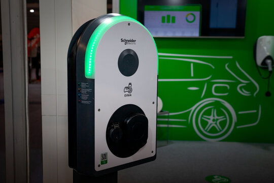 BELGRADE, SERBIA - MARCH 23, 2024: schneider electric car charger in a parking of Belgrade, used to charge power and electricity to electric vehicles and cars. schneider electric is a french company.