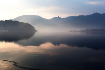 Fototapeta na wymiar View of the foggy lake in the morning