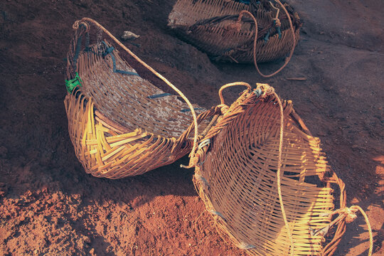 Close up of three woven wicker baskets that are used to gather and carry harvested salt in Kampot Cambodia that shows the authentic and traditional khmer local product