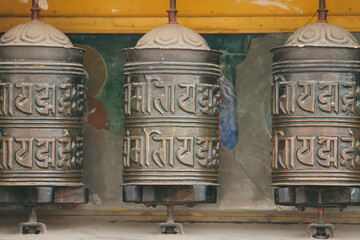 Tibetan prayer wheels with mantras embossed in it and representing spiritual practices in the...