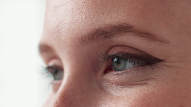 Open, eyes and lashes for health of vision, closeup and sight for looking in white background. Studio, person and adult with cosmetics of microblading of eyebrow on face with care for beauty