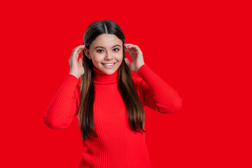 Casual style. Stylish girl has long hair. Teen monochrome fashion style. Style for girl. Headshot portrait of happy teen girl isolated on red. Teen girl looking at camera. Copy space