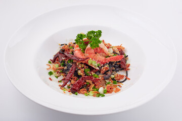 Black pasta stir fried chilli with shrimp topped with parsley, dried chilli, sliced spring onion, fried garlic, and cheese. Black spaghetti made from the ink in the squid.