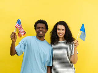 Happy Multiethnic Couple Holding American And European Union Flags - obrazy, fototapety, plakaty