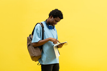 Young Student Exploring Adventure Map On Yellow Background. Concept Of Travel, Education, And...
