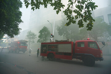 Fire trucks and firemen at the training of emergency fire drill in Hanoi