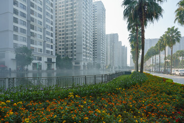 Flowers in the garden with the group of high rise apartment buildings in Hanoi, Vietnam