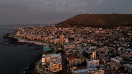aerial landscape view of area around Sea Point a district in Cape Town, South Africa with Signal Hill Mountain, during sunset 