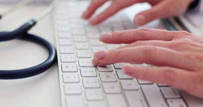 Doctor therapist or nurse hands typing on white computer keyboard