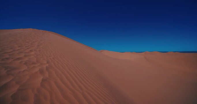 A panoramic sand dune of sahara desert at Mhamid el Ghizlane in Morocco tilt up