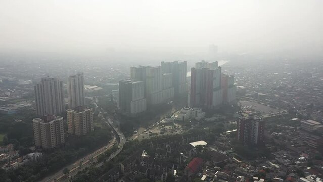 Wisma Atlet Jakarta Cityscape Enshrouded in Smog on a Hazy Morning With High-Rise Buildings