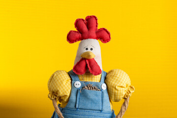 hen doll with vintage clothes yellow background