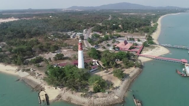 Scenic Aerial View of a Coastal Lighthouse and Pier on a Sunny Day, Bangka Belitung