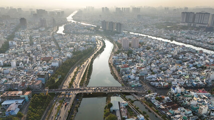 Ho chi Minh city aerial view with canal system, overcrowded riverside urban, Vo Van Kiet avenue along Tau Hu canal, dense density and crowded townhouse of big Asian town, Saigon, Viet Nam

