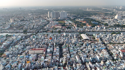 Amazing Aerial view of big Asian city, Ho Chi Minh scene, crowded riverside townhouse with dense density, urban overpopulated, Nguyen Tri Phuong street with bridge cross Tau Hu canal