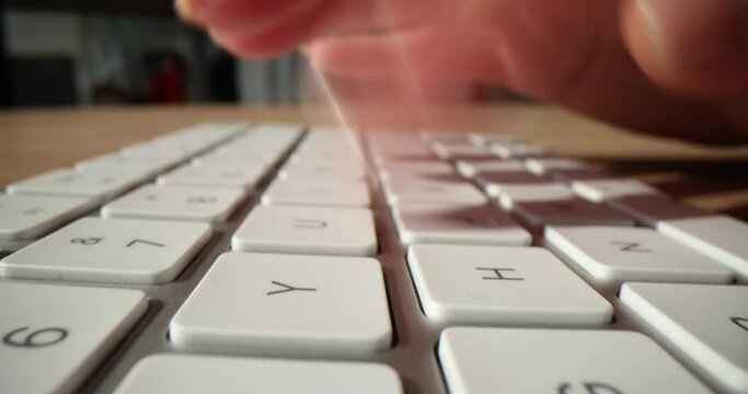 Programmer hand typing on computer keyboard closeup