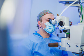 Operation under a surgical microscope for vision correction. Eye surgery. A patient and a surgeon...