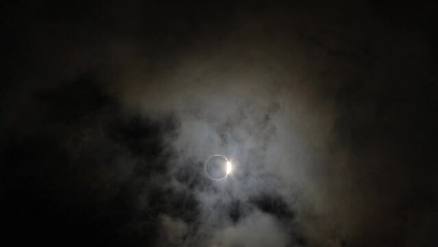 solar eclipse with clouds and fog. Astronomy phenomenon - without filter 